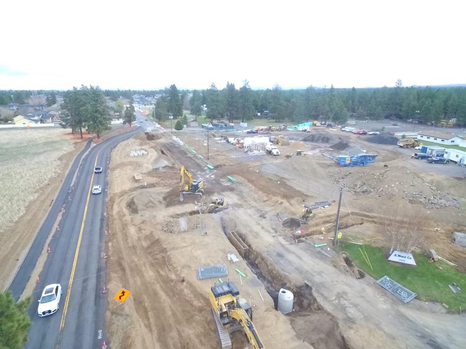 An aerial photo looking east over two way traffic using the temporary bypass road and work crews and equipment on the Murphy Road construction site.