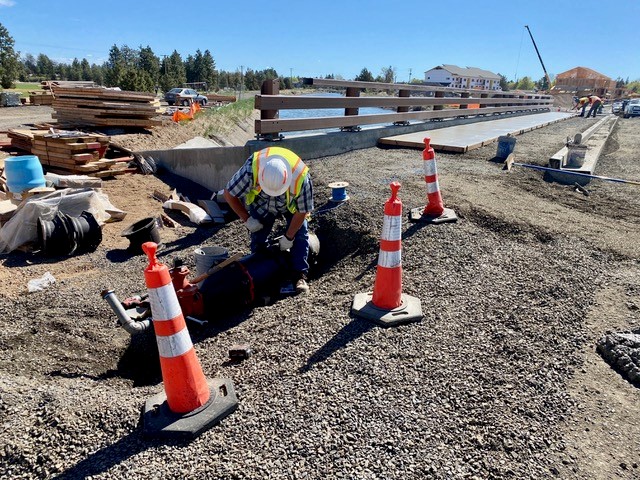 A photo of work crews installing a 12" Avion waterline along the Empire extension.