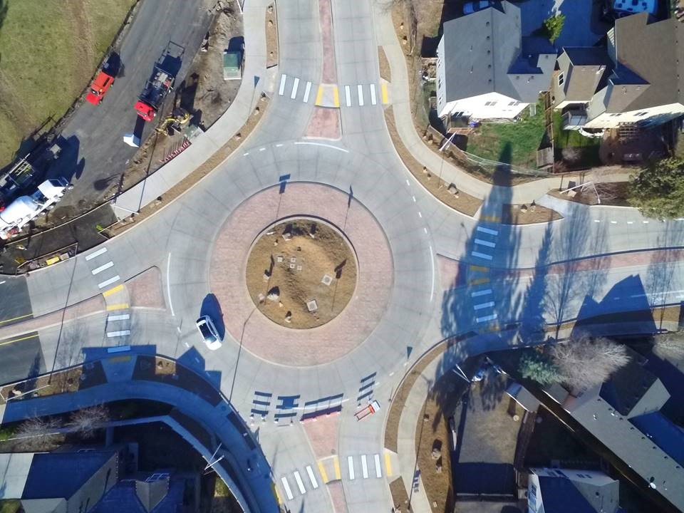 A birds-eye view of a white vehicle using the Brosterhous/Murphy roundabout.