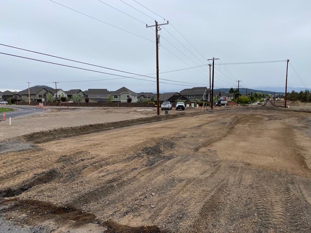 A photo of the Butler Market Road and Eagle Road construction site with work crews and equipment working in the background.