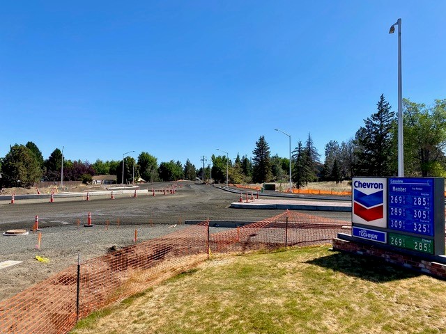A photo of the 27th Street construction area with cones and a Chevron gasoline rate sign on the side of the road in right side of the photo.