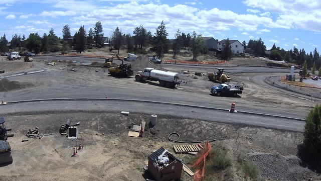 A photo of work crews and equipment working on construction of the 27th Street & Butler Market roundabout.
