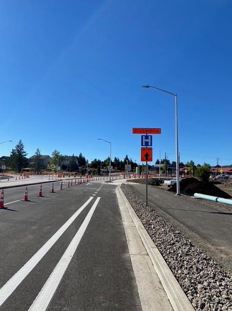 A photo of 27th Street facing south. There are cones set along the road and a hospital & detour road sign on the the shoulder of the road.