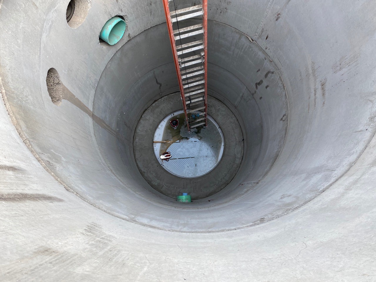 A photo looking down into a newly installed 26-ft deep manhole.