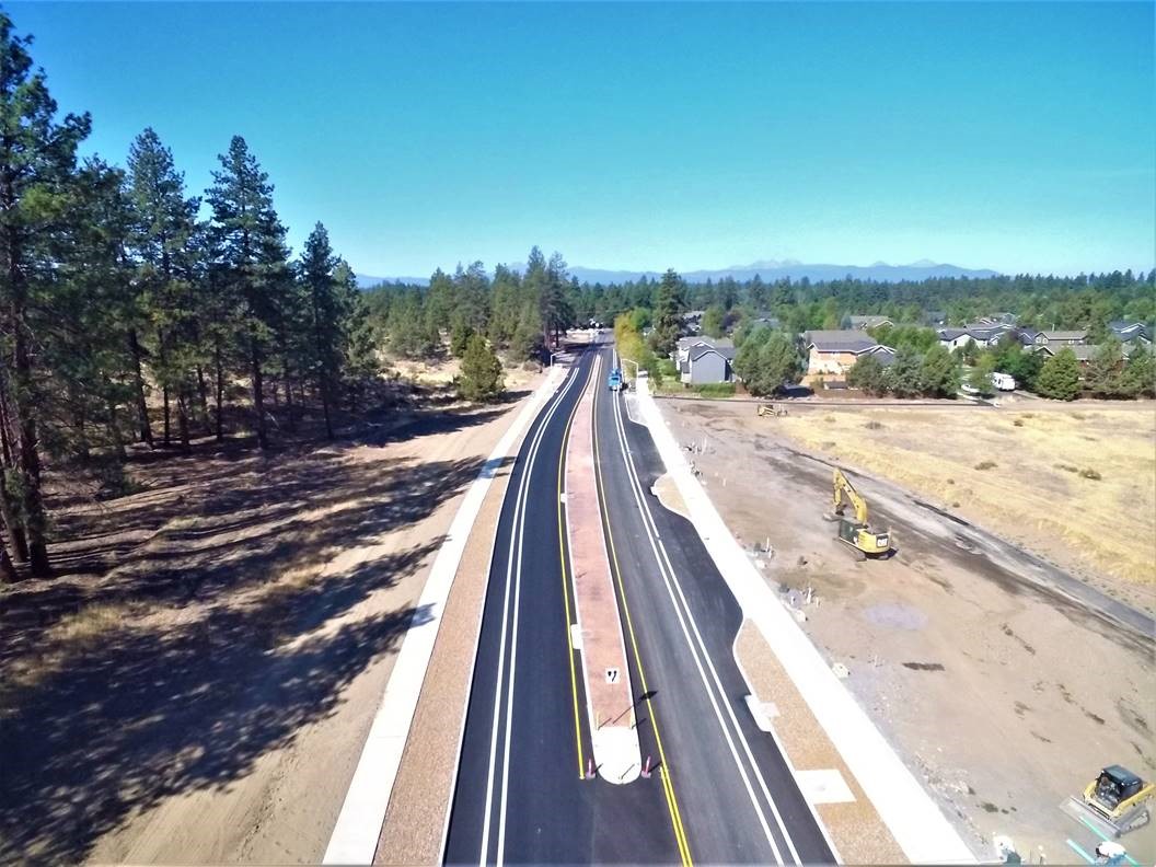 An aerial photo looking west over Murphy Road. There are excavation equipment to the right of the road.