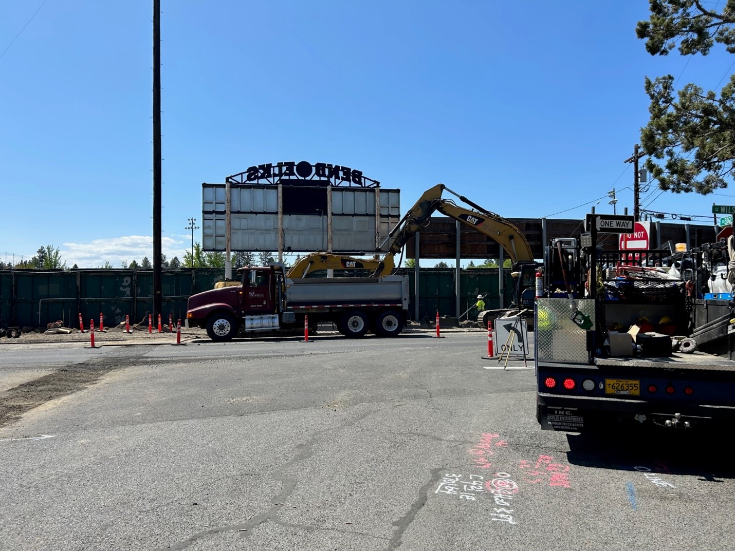 crews installing waterline. back of the vince genna stadium scoreboard.