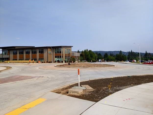 A photo looking north at the Simpson/Columbia roundabout with work crew members working in the background.