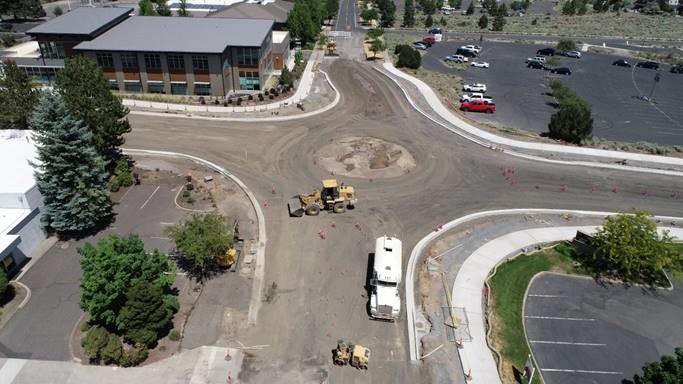 An aerial photo looking north over the established center circle of the roundabout and work crews prepping for the apron that forms the travel lane.