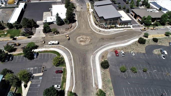 An aerial photo looking west over the new curbs and sidewalks forming the perimeter of the roundabout.