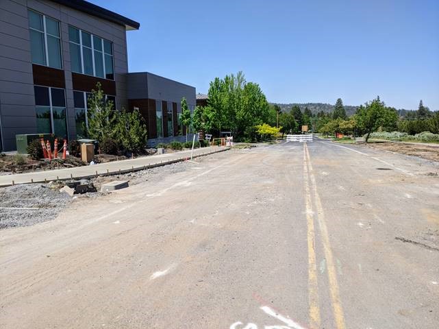 A photo of the new concrete sidewalks poured and curing for pedestrian use.