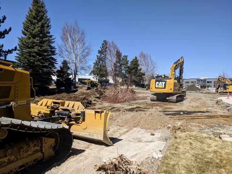 A photo of heavy equipment grading the project site in preparation for the aggregate base.