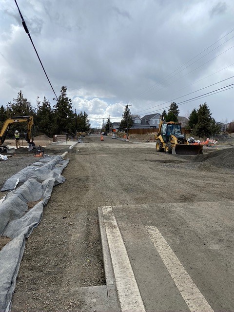 A photo of the construction crews and excavation equipment at the NE Purcell bridge construction site.