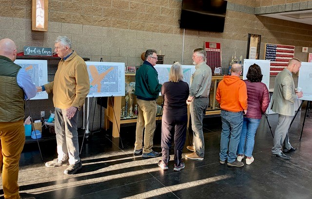 A photo of local residents looking at exhibits and meeting with project team members at the February 17th Open House.