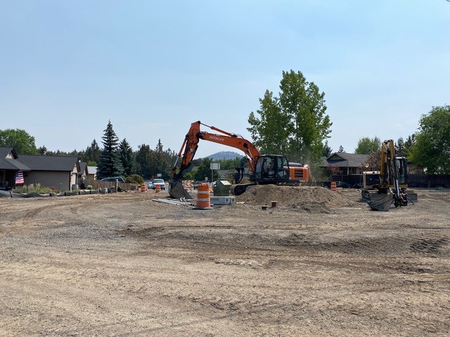 A photo looking south at excavation equipment and the new roundabout taking shape at NE Purcell Blvd and Butler Market Rd intersection.