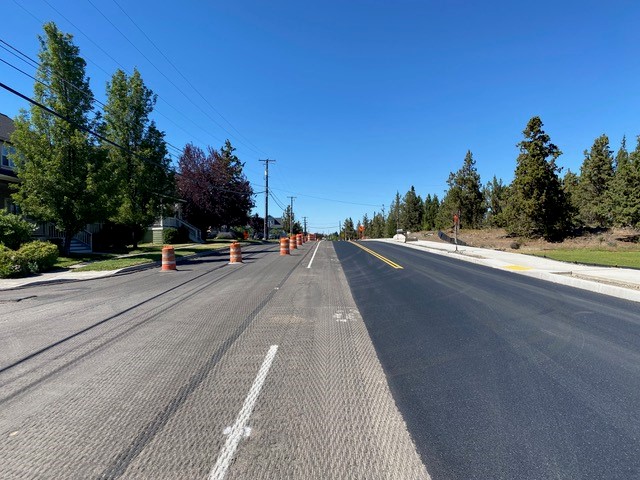 A photo of NE Purcell Blvd between the NUID canal and NE Castle Avenue. Driving lanes have shifted to the east side of the street.