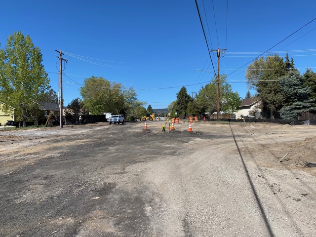 A photo of the road closure at Butler Market Road facing west. There are cones and barricades setup and the paved street has been cleared.