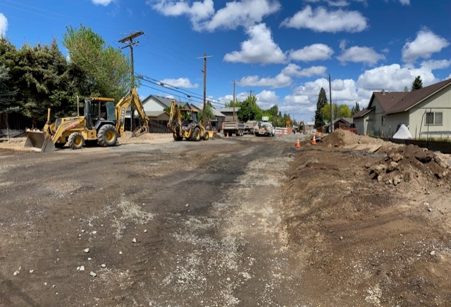 A photo of NE Purcell Blvd near Butler Market Road facing north. There are cones, barricades, and construction equipment at the project site.