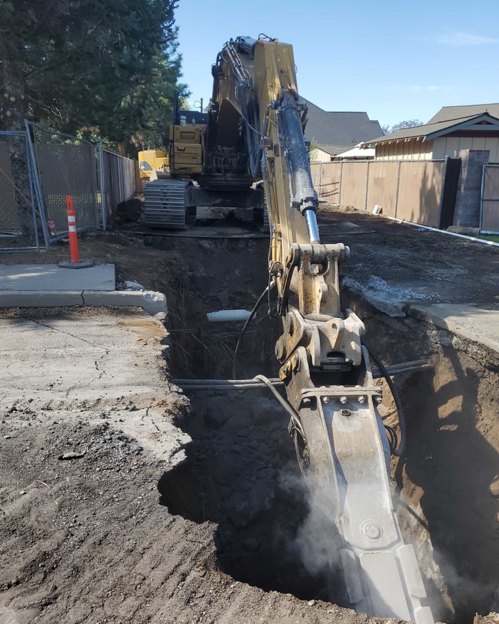 A photo of an excavator excavation across Ferguson Rd. into the Ridgewater II pump station.