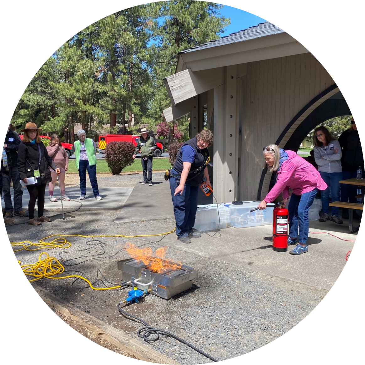 Person putting out fire with fire extinguisher