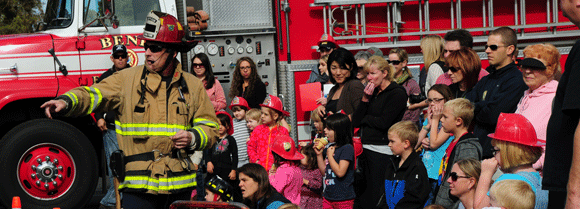 Kids with fire fighters.