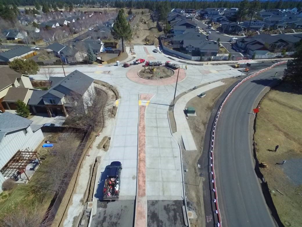 An aerial photo of the Brosterhous roundabout looking east over the construction site, trucks, and crew.