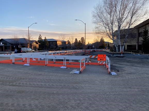 A photo of the Colorado Ave./Columbia St. intersection with barricades and a detour sign to direct pedestrian traffic.