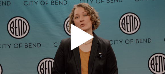 Bend Mayor Melanie Kebler in front of a backdrop