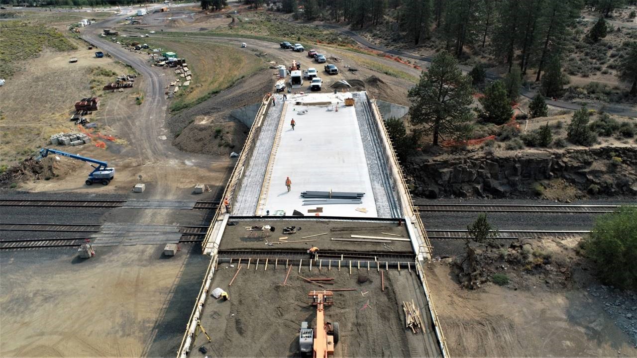 An aerial photo overlooking bridge work occurring over the railroad looking east.