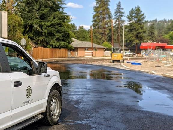 A photo of City of Bend personnel inspecting the finished pavement surface on Nashville Ave.