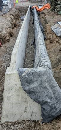 A photo of a stormwater planter on the southside of Newport Avenue after the concrete is poured and curing.