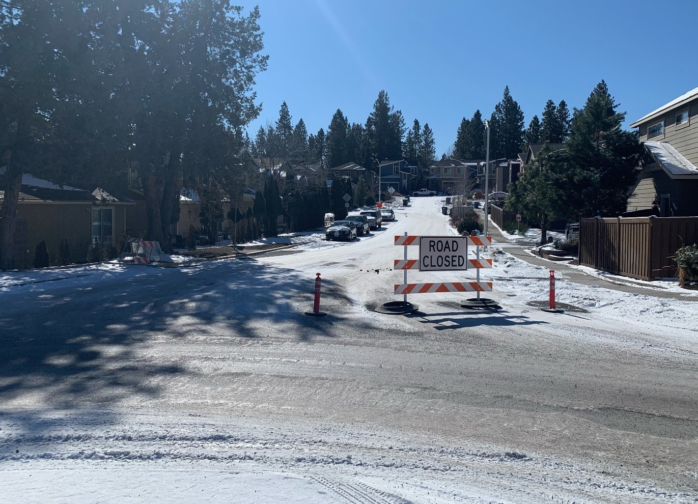 A photo of the road closure at Rockwood Lane. There is a barricade and two orange cones marking the road closure.