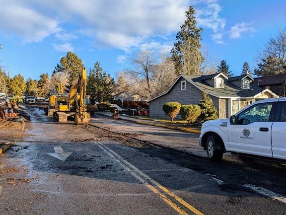 A photo of work crews using excavation equipment to remove the existing 12th Street waterline.