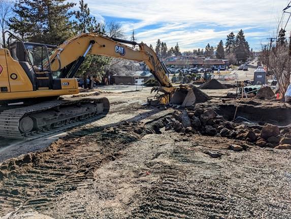 A photo of work crews using excavation equipment to excavate for the installation of the stormwater and water line facilities on 12th Street.