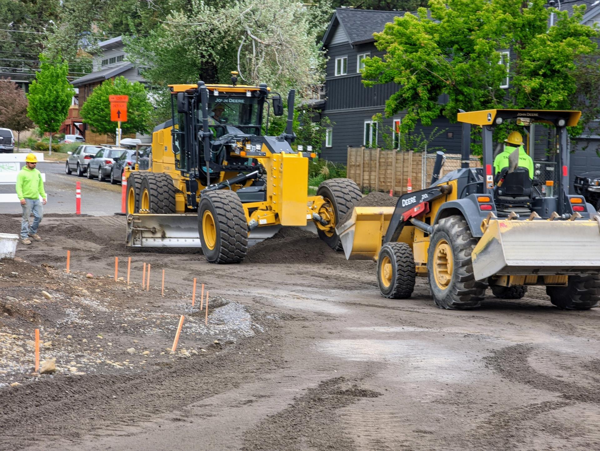 A photo of work crews using equipment to perform sub-grading on 11th Street.