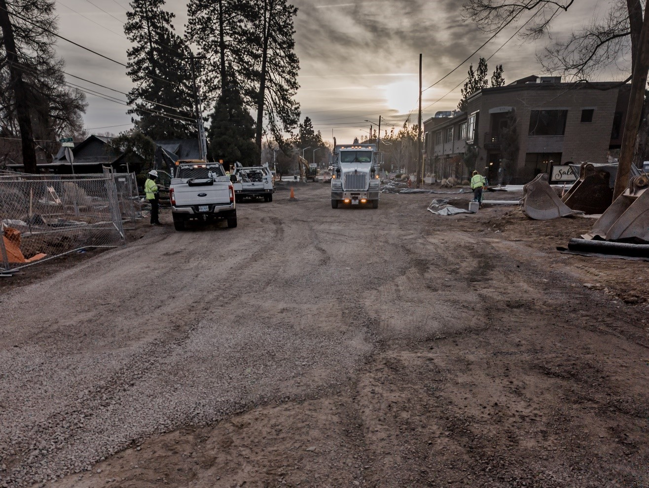 A photo of a truck delivering aggregate material in preparation for final grading on Newport Avenue.