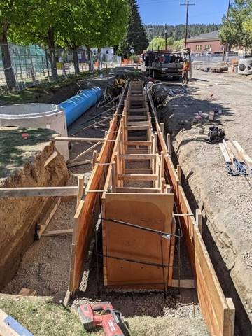 A photo of work crews placing forms for the planter walls.