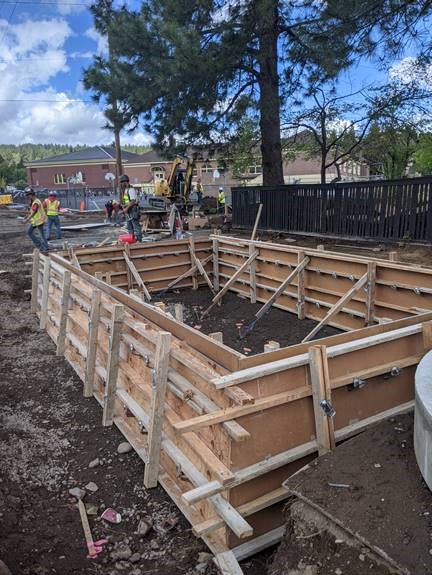 A photo of work crews and the stormwater planters formed and ready to be poured with concrete.