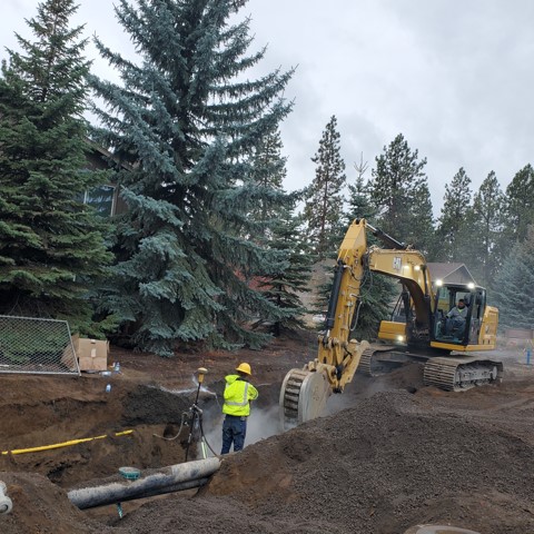 A photo of work crews using an excavator to excavate near NW Knoxville Blvd. & NW Newport Ave.