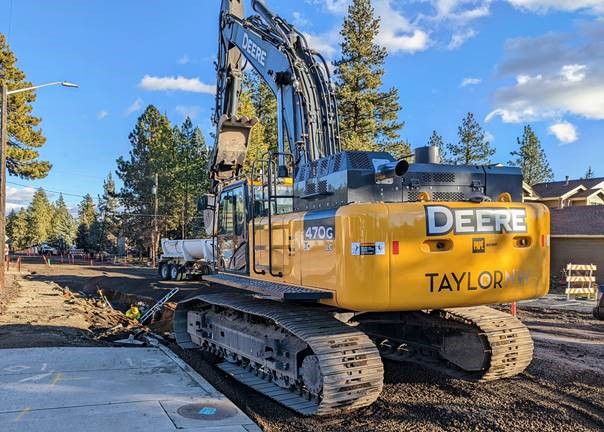Work crews are using a large excavator to remove the old watermain line beneath Newport Ave.