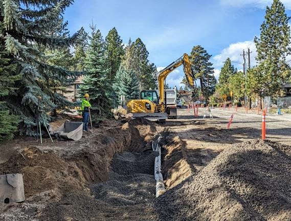 A photo of work crews using excavation equipment to excavate for the stormwater planter location at Knoxville Blvd. & Newport Ave.