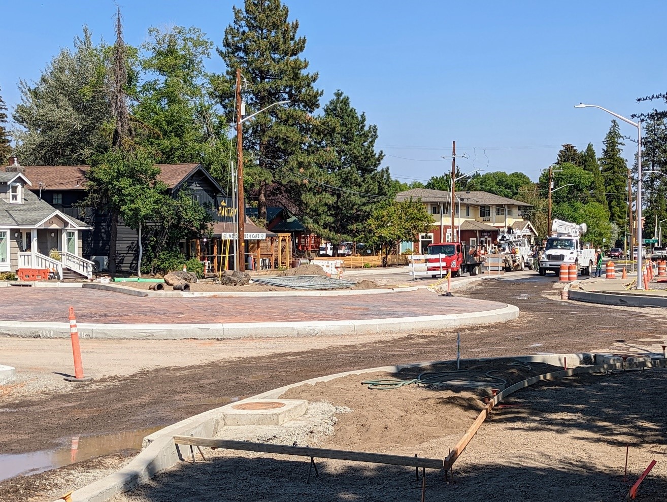 A photo of Newport Ave. facing east and the new dogbone roundabout with curbs and concrete apron complete.