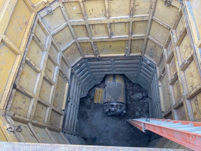 A photo looking down into the OR 97 crossing maintenance hole on the west side of the highway.