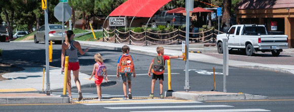 Kids crossing a street.