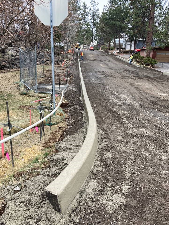 A photo of work crews performing new curb work along Cinder Ln.