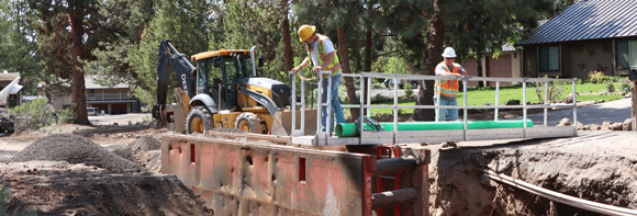 A crew installing a sewer line.