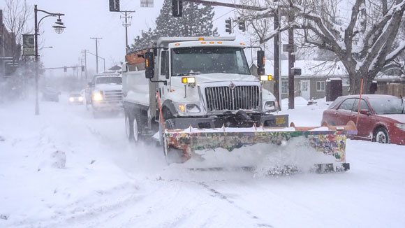Snow plow plowing snow.