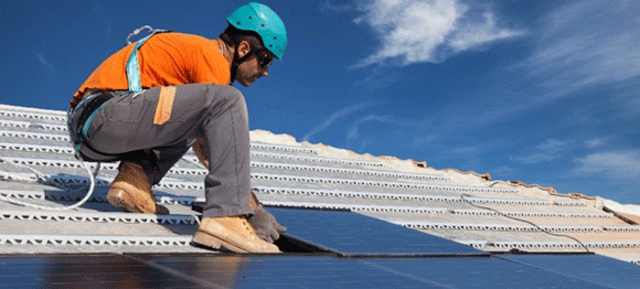 A man installing solar panels.
