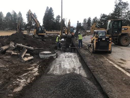 A photo of utiility work crews and equipment along Murphy Rd.