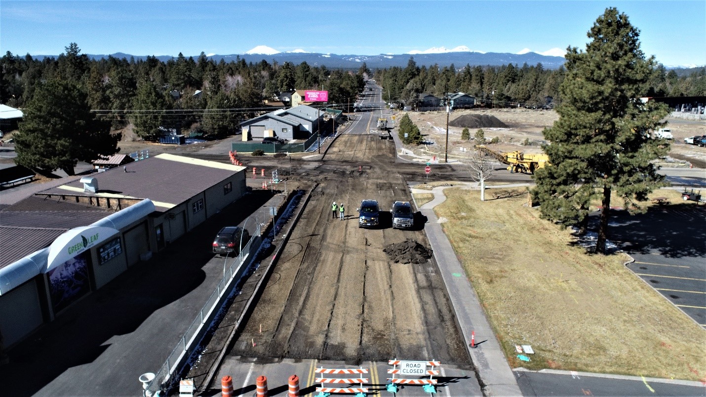 An aerial photo overlooking the street excavation work  at 9th Street & Wilson Avenue, facing west. There are cones and barricades marking the road closure.