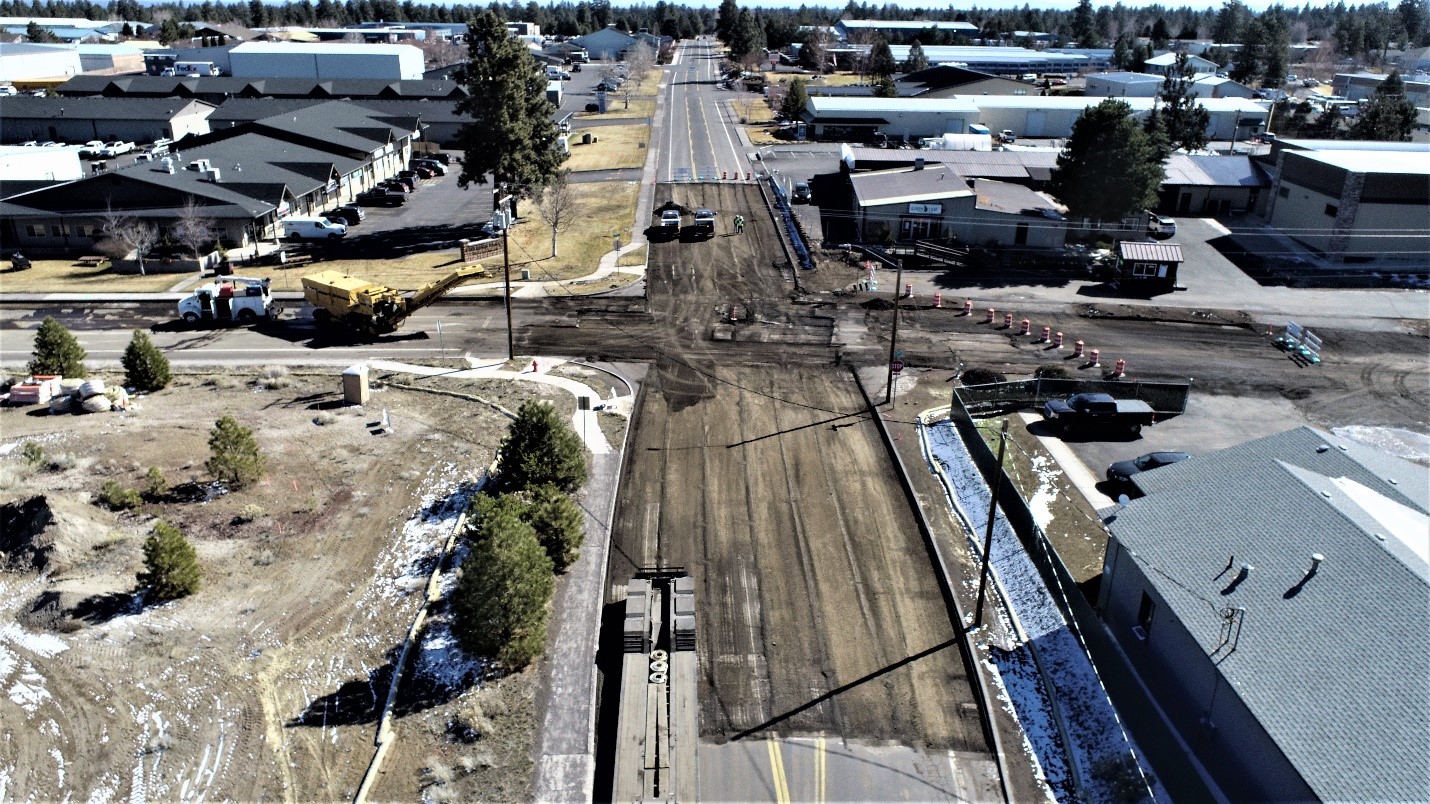 An aerial photo overlooking the street and curb excavation of 9th Street and Wilson Avenue, facing east.